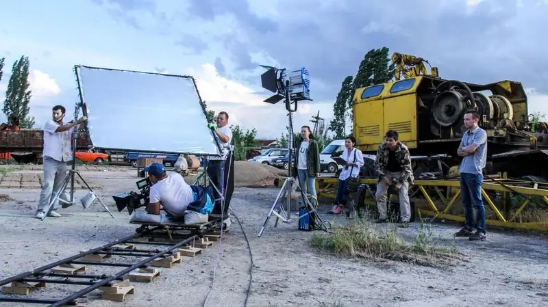 Dolly shot on track with a butterfly frame on an outdoor set